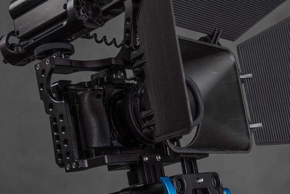 Close-up of a professional video camera setup with a rig and matte box, ideal for studio shoots.