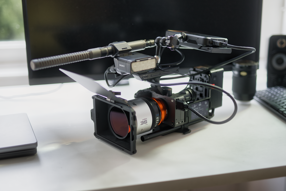 Close-up of professional video camera setup with microphone in studio.