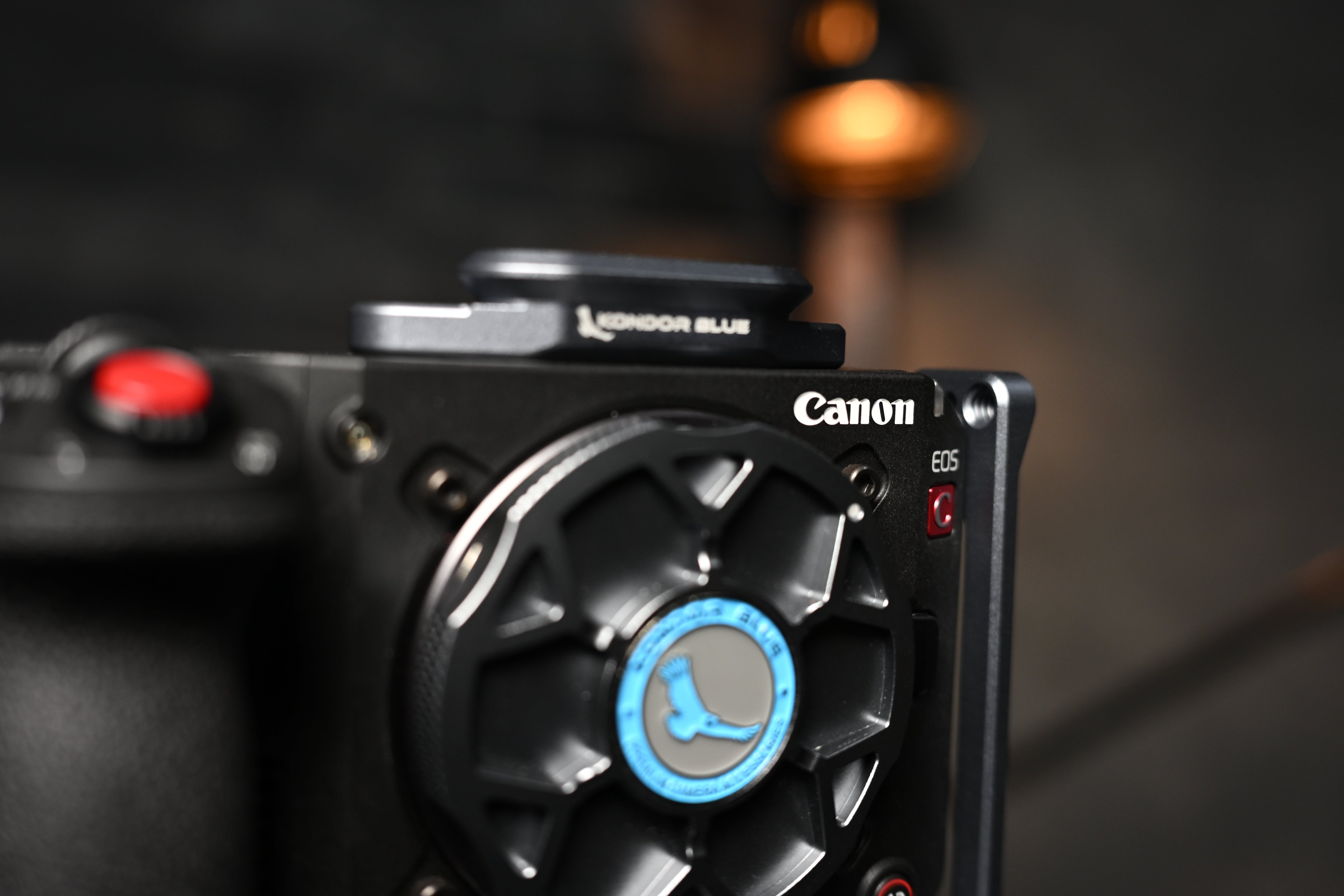 Canon C50 rigged with KONDOR BLUE modular camera cage, handles, and mounted accessories in a professional video production setup